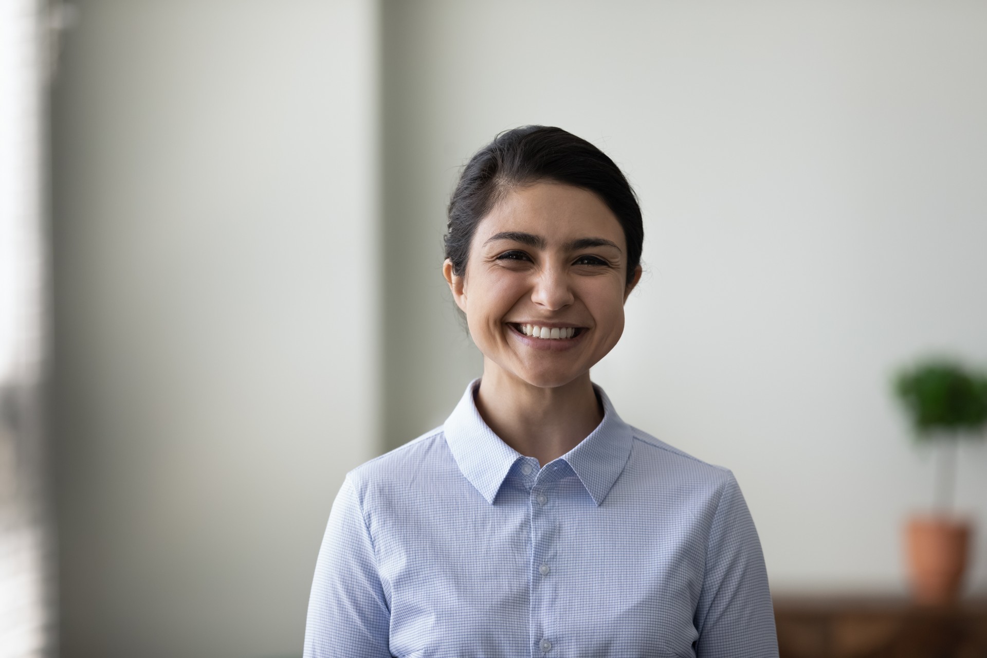 Head shot portrait of happy young Indian business leader